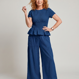 Eirenne | Krokots tops ar peplum detaļu un platu staru bikšu komplekts