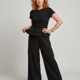 Eirenne | Krokots tops ar peplum detaļu un platu staru bikšu komplekts